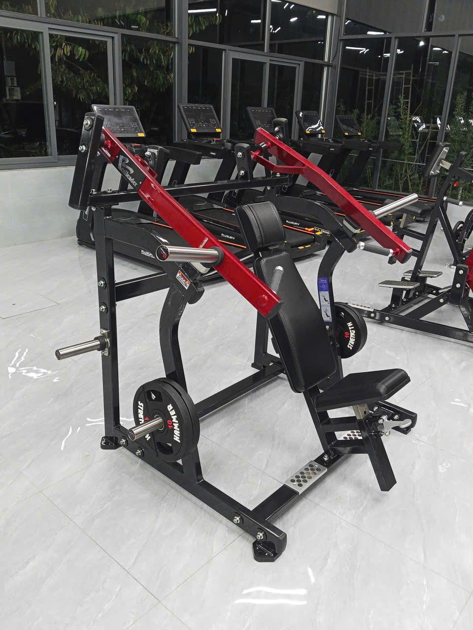 Máy tập kháng lực với kết cấu khung thép, ghế tựa và tay đòn.